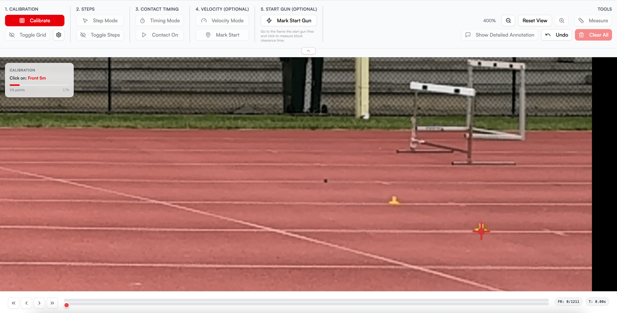 The TrackStat calibration screen. A panel on the left reads 'Click on: Front 5m'; out on the track a crosshair is placed on a small cone beside a hurdle.