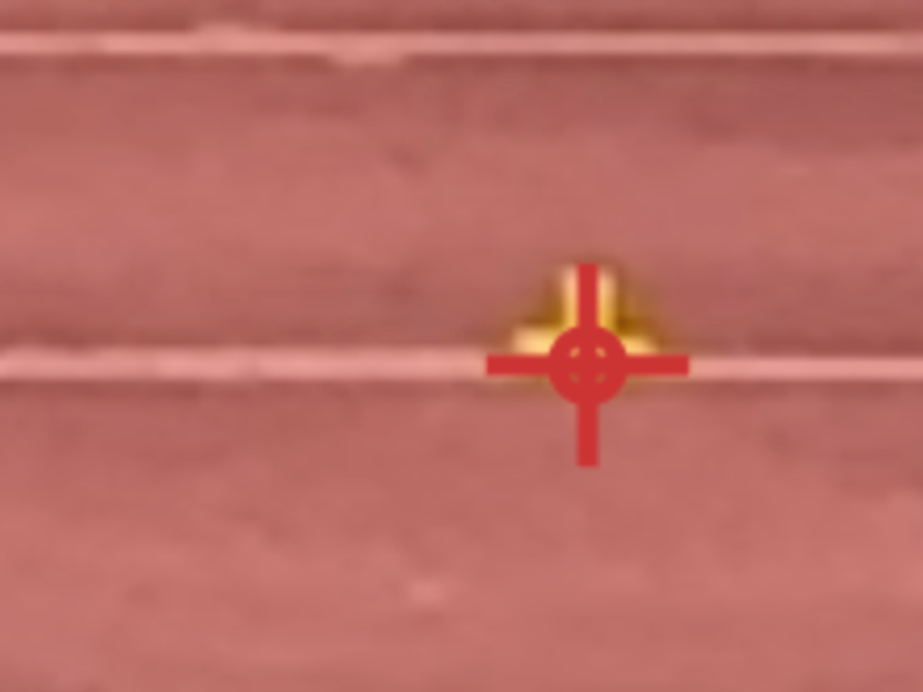 Close-up of the crosshair on a calibration cone: the horizontal line sits on the cone's base where it meets the lane, and the vertical line runs up the centre of the cone.